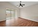 Bedroom featuring wood floors, a ceiling fan, neutral walls, and sliding doors to a screened patio at 7034 Pine Hollow Dr, Mount Dora, FL 32757