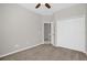 Bedroom featuring neutral colors, carpet, a ceiling fan, closet, and open door to the en suite at 7034 Pine Hollow Dr, Mount Dora, FL 32757