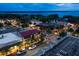 Night cityscape with streetlights illuminating buildings, cars, and sidewalks along a waterfront view at 7034 Pine Hollow Dr, Mount Dora, FL 32757