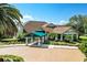 Attractive exterior of The Country Club of Mount Dora, showcasing a covered entrance and lush landscaping at 7034 Pine Hollow Dr, Mount Dora, FL 32757