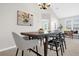 Inviting dining area with a modern chandelier, stylish table and chairs, and bright natural light at 7034 Pine Hollow Dr, Mount Dora, FL 32757