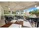The dining area boasts views of the golf course and abundant seating with tables set with plates and silverware at 7034 Pine Hollow Dr, Mount Dora, FL 32757