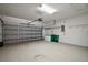 Spacious garage with ample storage area, epoxy flooring, and an automatic door at 7034 Pine Hollow Dr, Mount Dora, FL 32757