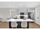 Contemporary kitchen featuring gray cabinetry, stainless steel appliances, a large island, and stylish countertops at 7034 Pine Hollow Dr, Mount Dora, FL 32757