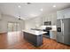 Bright, open kitchen featuring an island, modern appliances, and sliding door to the backyard at 7034 Pine Hollow Dr, Mount Dora, FL 32757
