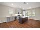 Bright kitchen featuring gray cabinets, stainless steel appliances, and a center island at 7034 Pine Hollow Dr, Mount Dora, FL 32757