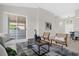 Comfortable living room with a sliding glass door to a screened patio, neutral colors, and an inviting atmosphere at 7034 Pine Hollow Dr, Mount Dora, FL 32757