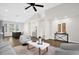 Spacious living room featuring modern decor, neutral colors, archways, and seamless flow to the kitchen area at 7034 Pine Hollow Dr, Mount Dora, FL 32757