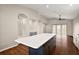 Large kitchen island with seating complements the open floor plan and sliding glass doors at 7034 Pine Hollow Dr, Mount Dora, FL 32757