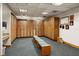 The locker room includes bench seating, a vanity and mirror, and wood lockers at 7034 Pine Hollow Dr, Mount Dora, FL 32757