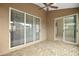 Relaxing covered patio with sliding glass doors, featuring a tiled floor and serene ambiance at 7034 Pine Hollow Dr, Mount Dora, FL 32757