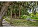 Picturesque picnic area surrounded by live oak trees and lush greenery, ideal for outdoor gatherings at 7034 Pine Hollow Dr, Mount Dora, FL 32757