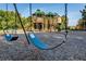 Neighborhood playground featuring swings and a play structure, perfect for Gathering fun at 7034 Pine Hollow Dr, Mount Dora, FL 32757