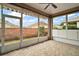 This screened porch offers great outdoor views with its floor and ceiling fan at 7034 Pine Hollow Dr, Mount Dora, FL 32757