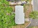 Aerial view of a gray-roofed home with a truck parked nearby showing the layout of the house and the surrounding greenery at 706 Michigan St, Mount Dora, FL 32757