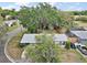 This aerial view shows the home, large trees, and the property's perimeter at 706 Michigan St, Mount Dora, FL 32757