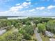 Beautiful aerial view of a neighborhood with lush greenery and a stunning lake in the background on a sunny day at 706 Michigan St, Mount Dora, FL 32757