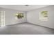 Bright, carpeted room with multiple windows for ample natural light at 706 Michigan St, Mount Dora, FL 32757