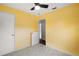 This bedroom features neutral carpet and yellow walls at 706 Michigan St, Mount Dora, FL 32757