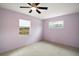 Bright bedroom with carpet flooring and natural light from two windows at 706 Michigan St, Mount Dora, FL 32757