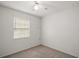 This bedroom features a window, neutral carpet, and white walls at 706 Michigan St, Mount Dora, FL 32757