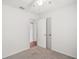 This bedroom features neutral carpet, closet, and white walls at 706 Michigan St, Mount Dora, FL 32757