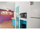 Kitchen area with turquoise cabinets, built-in microwave, and access to a patio at 706 Michigan St, Mount Dora, FL 32757