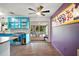 Bright kitchen featuring turquoise cabinetry, stainless steel appliances, and access to an outdoor patio at 706 Michigan St, Mount Dora, FL 32757