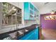 Charming kitchen with turquoise cabinets, granite countertops, and natural light at 706 Michigan St, Mount Dora, FL 32757