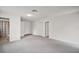 Spacious, carpeted living room with neutral walls and access to the bathroom at 706 Michigan St, Mount Dora, FL 32757