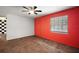 Spacious living room featuring wood-look floors, ample light, and modern ceiling fan at 706 Michigan St, Mount Dora, FL 32757