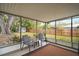 Inviting screened patio features comfortable seating and a peaceful backyard view at 706 Michigan St, Mount Dora, FL 32757