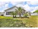 Spacious backyard with palm trees and a view of the home's exterior at 767 Barbados Pl, The Villages, FL 32162