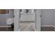 Bathroom with double vanity sinks, and linen storage showcasing a view to the closet and additional rooms at 767 Barbados Pl, The Villages, FL 32162