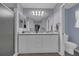 Well-lit bathroom featuring double sinks, a large mirror, and modern fixtures for convenience at 767 Barbados Pl, The Villages, FL 32162