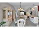 Bright dining room with a glass table, chandelier, and large built-in cabinets at 767 Barbados Pl, The Villages, FL 32162