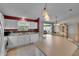 Bright kitchen with white cabinets, modern appliances and seamless transition to the dining area at 767 Barbados Pl, The Villages, FL 32162