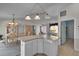 Open concept kitchen with a stylish island, dining area, and modern lighting at 767 Barbados Pl, The Villages, FL 32162