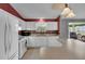Functional kitchen equipped with modern appliances, white cabinetry, and a view to the serene outdoors at 767 Barbados Pl, The Villages, FL 32162