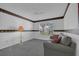 Comfortable living room with a sofa, window, and ambient lighting, perfect for relaxation and entertainment at 767 Barbados Pl, The Villages, FL 32162