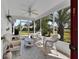 Enclosed porch with wicker furniture and a ceiling fan, perfect for outdoor relaxation at 767 Barbados Pl, The Villages, FL 32162