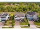 Aerial view of a gray home showcasing solar panels and landscaping in a suburban neighborhood at 769 Daybreak Pl, Longwood, FL 32750