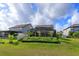 Lush green backyard featuring a screened pool, mature trees, and beautiful landscaping at 769 Daybreak Pl, Longwood, FL 32750