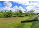 Expansive backyard with lush green grass, manicured landscaping, and serene outdoor setting at 769 Daybreak Pl, Longwood, FL 32750
