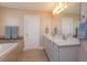 Bathroom featuring double sinks, marble countertops, and a soaking tub at 769 Daybreak Pl, Longwood, FL 32750