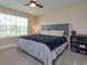 Cozy bedroom featuring a large window, king-size bed, and a ceiling fan for added comfort at 769 Daybreak Pl, Longwood, FL 32750