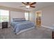 Main bedroom with neutral carpet and a tufted headboard at 769 Daybreak Pl, Longwood, FL 32750