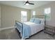 Bright bedroom featuring a metal-framed bed, natural light and ceiling fan at 769 Daybreak Pl, Longwood, FL 32750