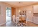Bright dining area with a wood table, white chairs and a decorative cabinet and lighting at 769 Daybreak Pl, Longwood, FL 32750