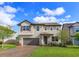 Two-story home featuring a brick paver driveway, two-car garage, and a well-manicured lawn at 769 Daybreak Pl, Longwood, FL 32750